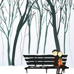 Парень с девушкой сидят на скамейке в парке зимой