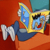 Том из мультфильма 'том и джерри' лежит в кресле ...