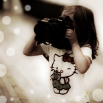  Девочка в <b>футболке</b> с hello kitty держит в руках фотоаппарат 