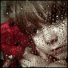 Грустная девочка с цветком и каплями дождя