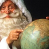 Дед Мороз указывает на  глобус